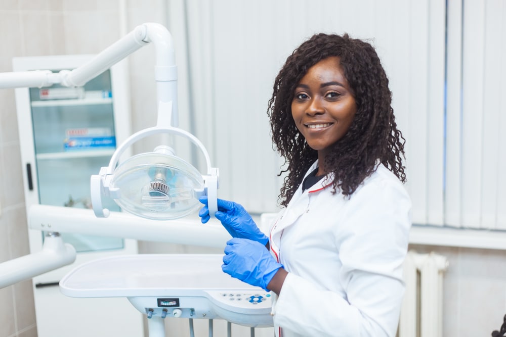 dental assistant smiling and posing in a dental office